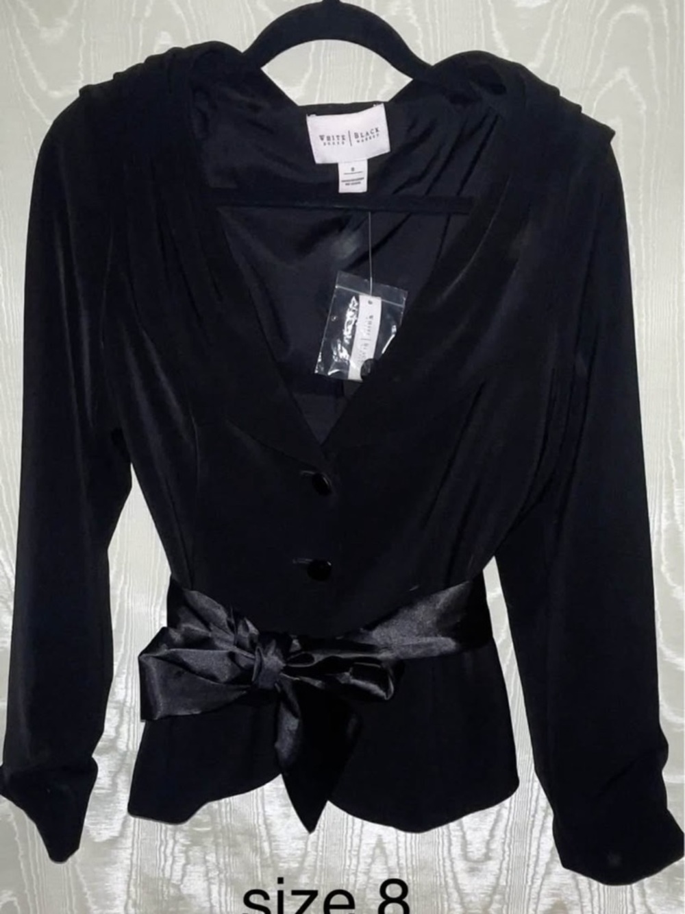 White House Black Market Black Satin sash tie into a bow.  Elegant and classy.